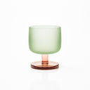 Antigua wine glass with a pistachio-green frosted bowl and rose-tinted stem