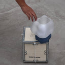 Hand placing the 3D printed cloud shade on the petrol-blue Studio.LUNA L001 lamp